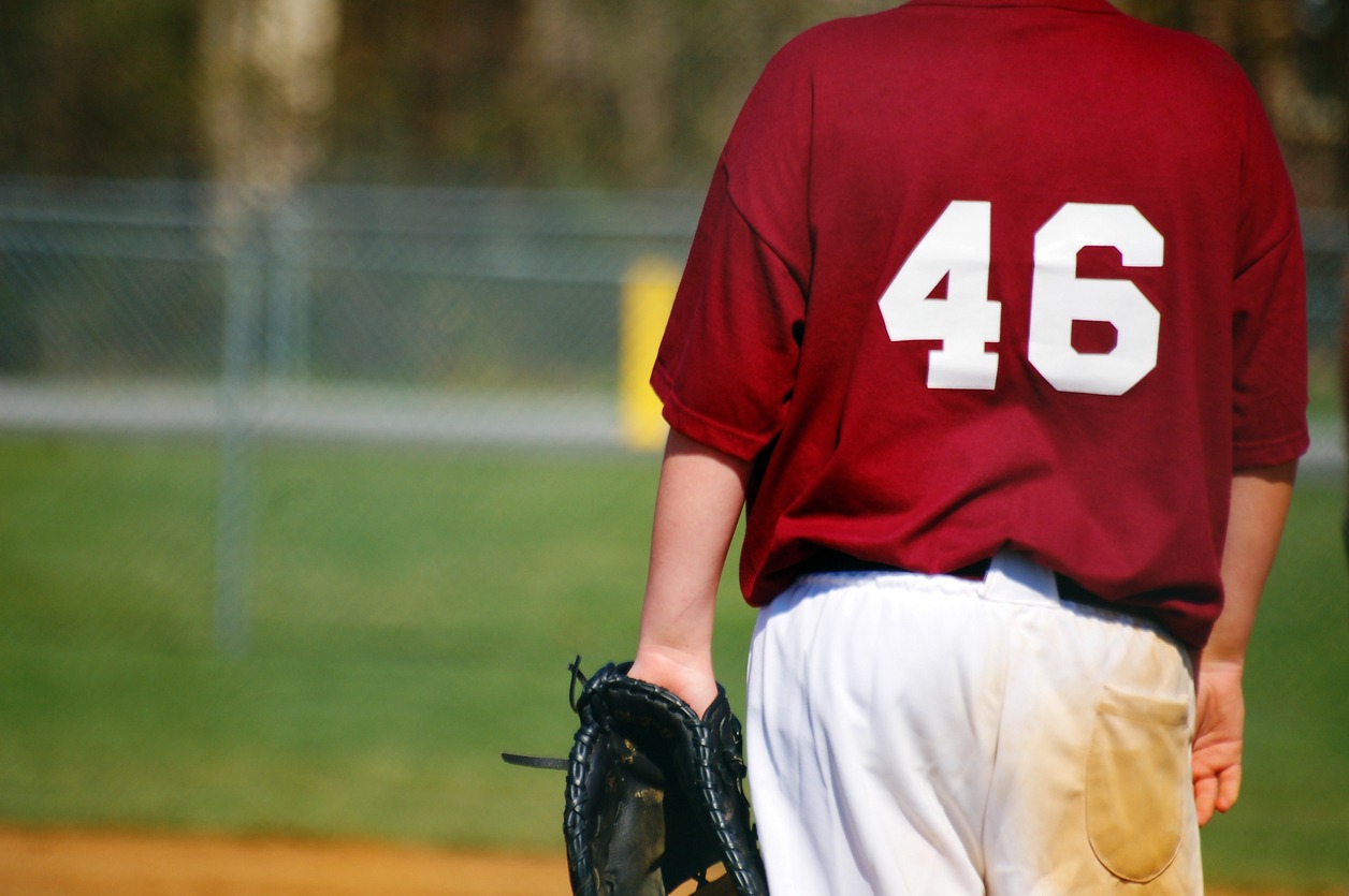 A baseball player wearing baseball pants with dirt stains