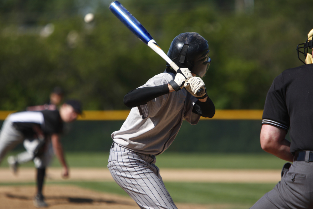 A batter about to hit a pitch during a baseball game