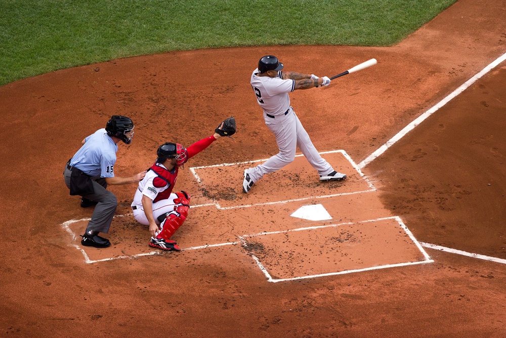 A New York Yankees batter (Andruw Jones) and a Boston Red Sox catcher at Fenway Park