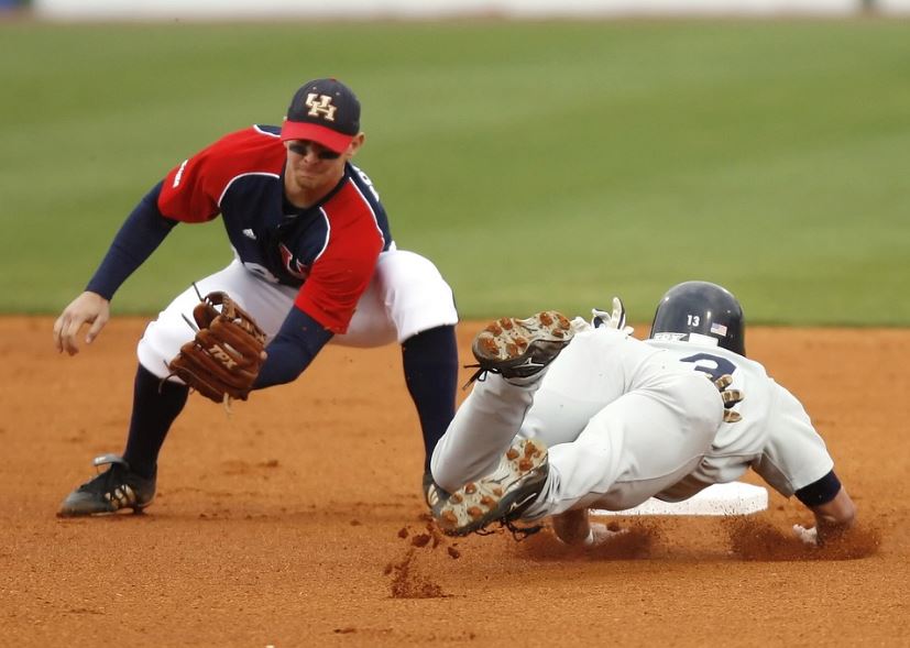 player with eye black catching a baseball