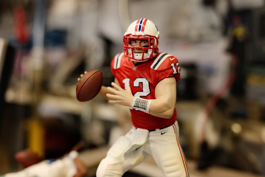 toy figure of Tom Brady wearing eye black paint