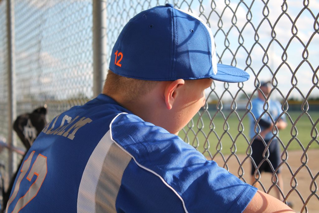  player wearing a jersey and a baseball cap