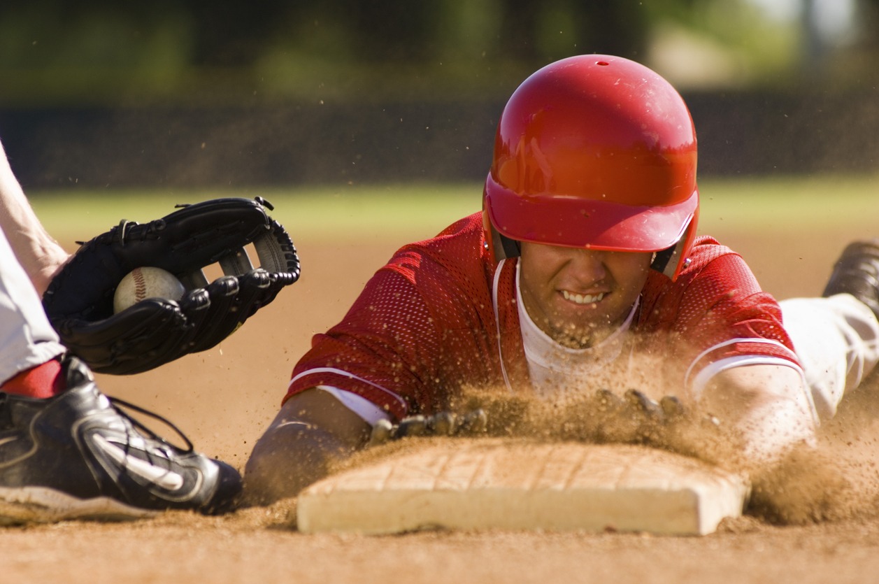 A baseball player sliding into base