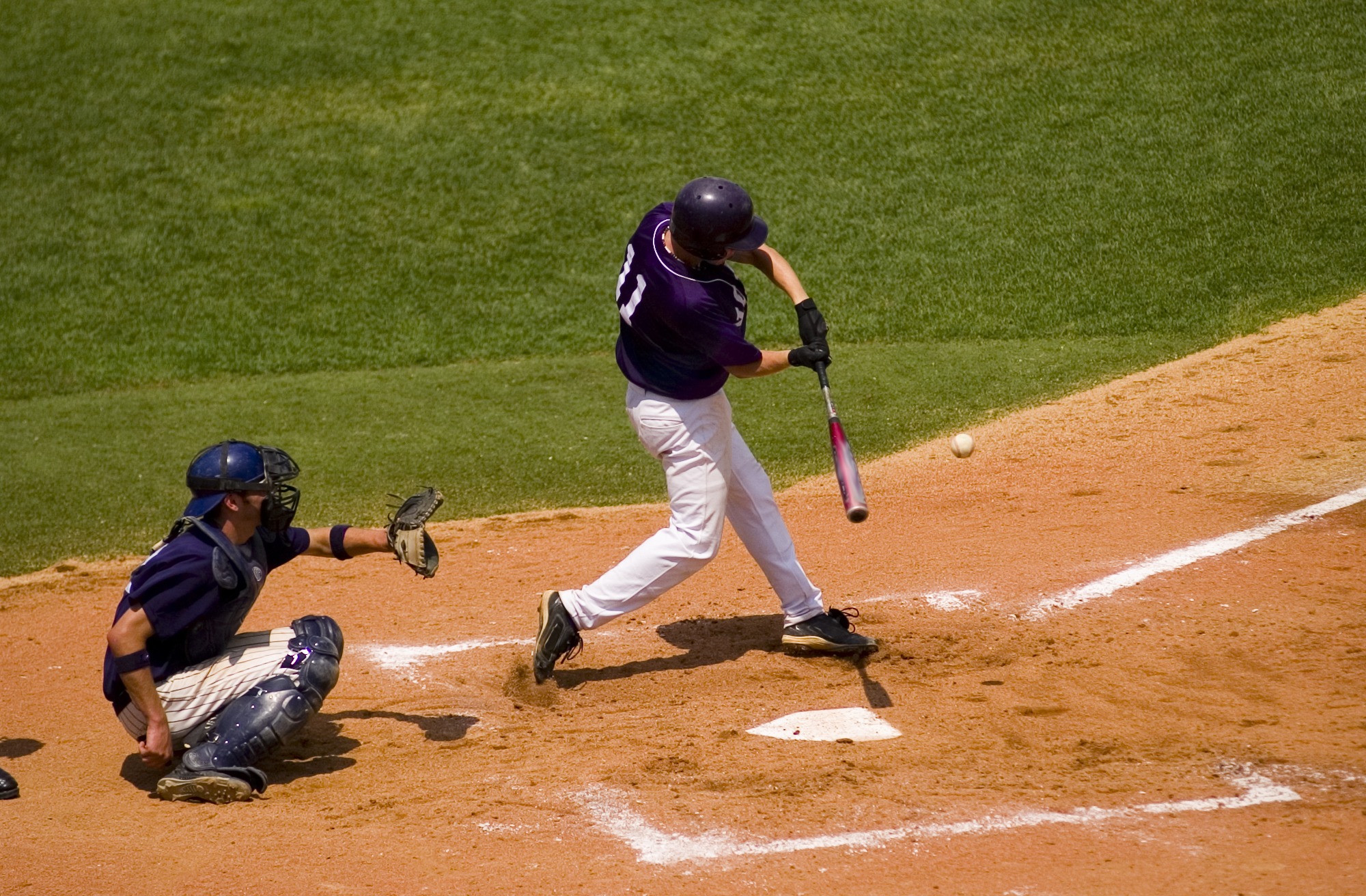 A batter hitting a pitched ball